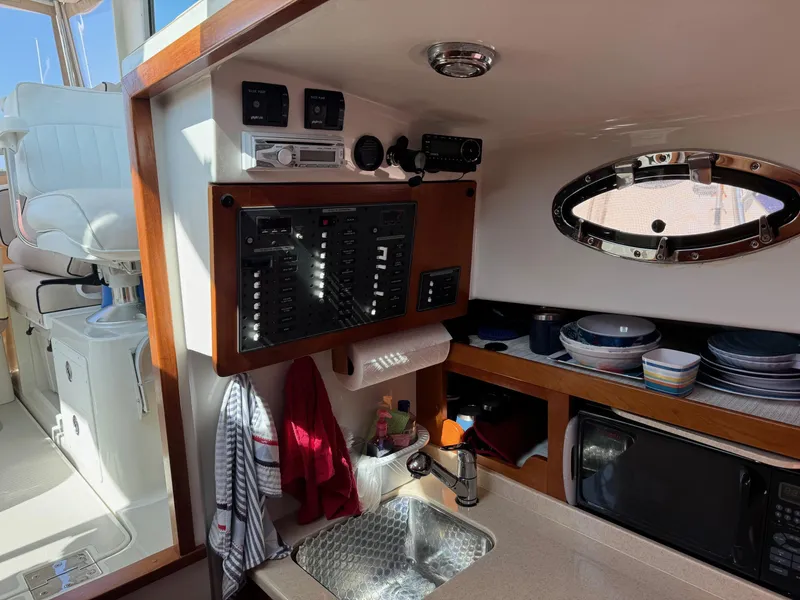Slide: The Image of 2007 Back Cove 29 boat interior with control panel, sink, and microwave. - 6