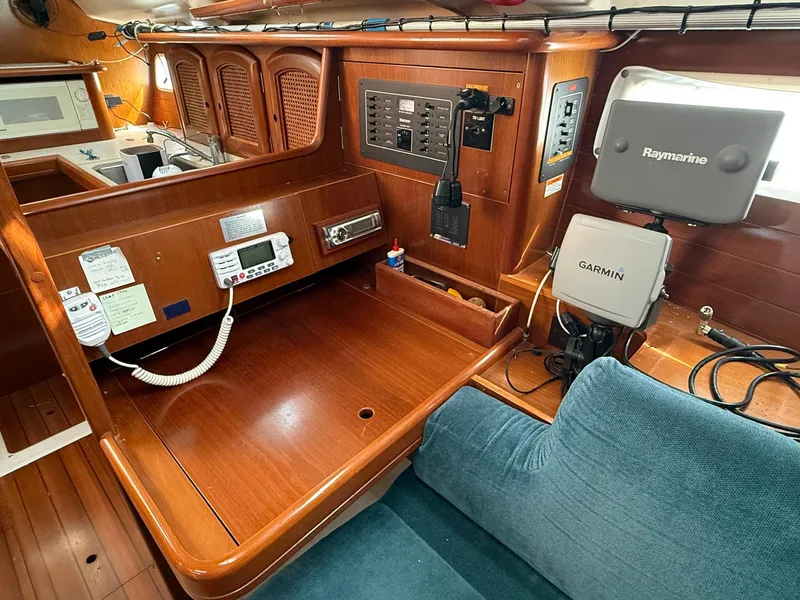 Slide: The Image of 1998 Beneteau Oceanis 352 interior with navigation equipment and wooden cabinetry. - 16