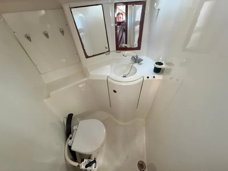 Slide: The Image of Bathroom of 1998 Beneteau Oceanis 352 yacht with toilet, sink, and mirror. - 18