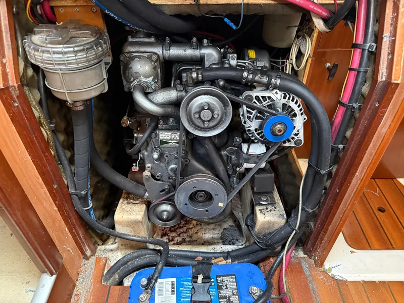 Slide: The Image of Engine compartment of a 1998 Beneteau Oceanis 352 sailboat, showing detailed mechanical components. - 19