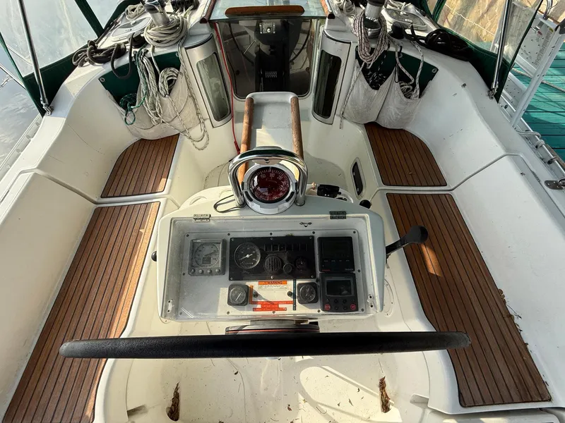 Slide: The Image of Cockpit of 1998 Beneteau Oceanis 352 sailboat with steering wheel and navigation instruments. - 2