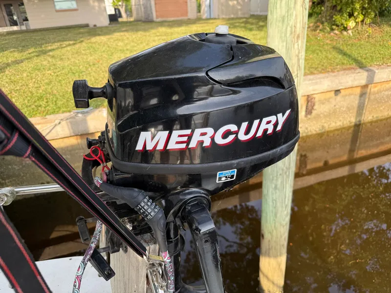 Slide: The Image of Mercury outboard motor on a 1998 Beneteau Oceanis 352 sailboat, docked by a canal. - 21