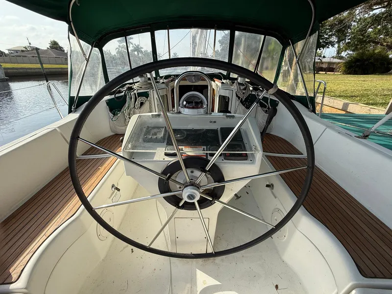 Slide: The Image of Cockpit view of 1998 Beneteau Oceanis 352 sailboat with large steering wheel and wooden deck. - 5