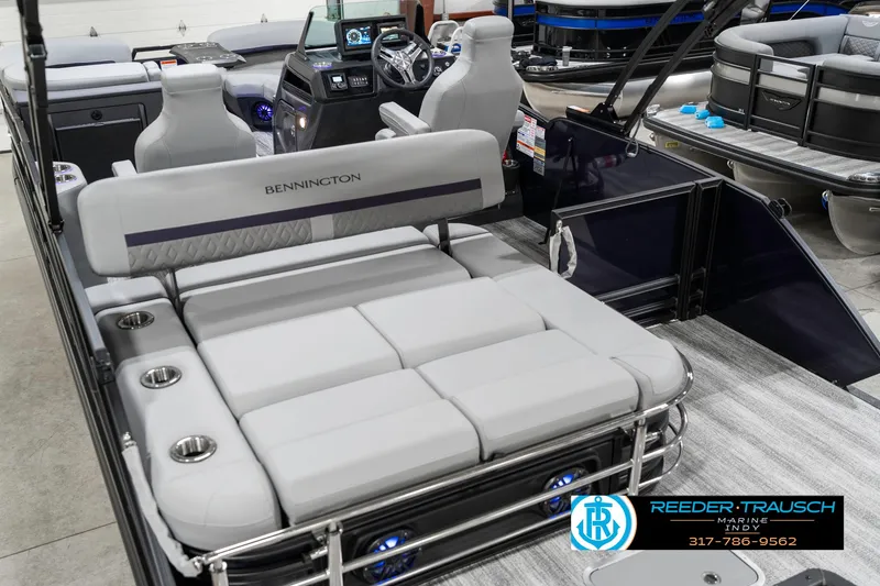Slide: The Image of 2025 Bennington 22 MSB pontoon boat interior with plush seating and modern dashboard. - 14