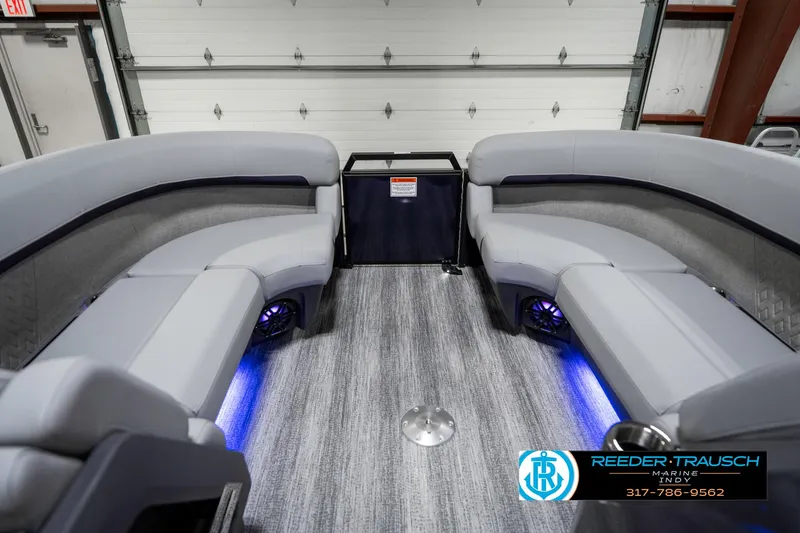 Slide: The Image of 2025 Bennington 22 MSB boat interior with gray seating and blue LED lighting. - 21