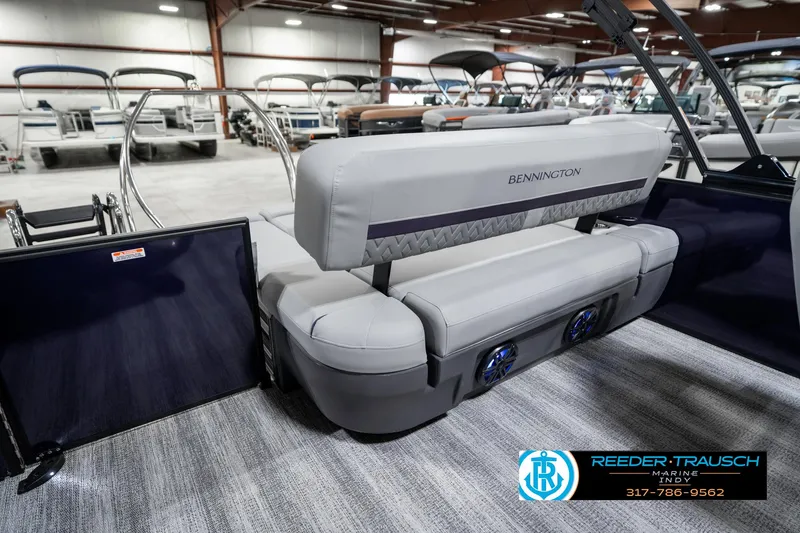 Slide: The Image of 2025 Bennington 22 MSB pontoon boat interior with plush seating in showroom. - 29