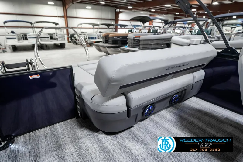 Slide: The Image of 2025 Bennington 22 MSB pontoon boat interior with plush seating in showroom. - 30