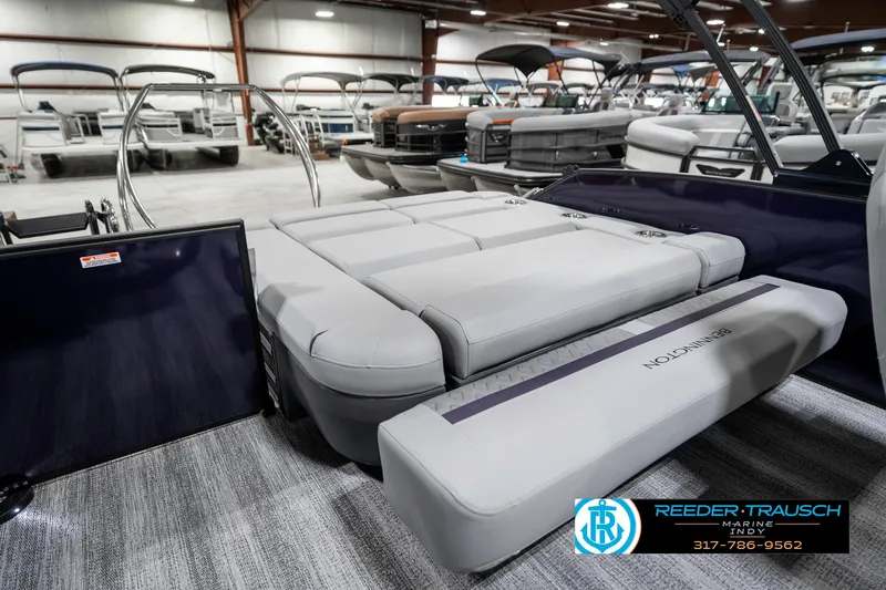 Slide: The Image of 2025 Bennington 22 MSB pontoon boat interior with luxurious seating in showroom. - 31
