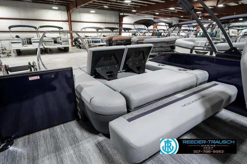 Slide: The Image of 2025 Bennington 22 MSB pontoon boat interior with plush seating in showroom. - 34
