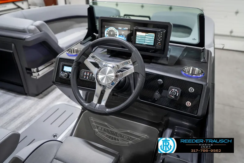 Slide: The Image of 2025 Bennington 22 MSB boat dashboard with steering wheel and digital displays. - 37