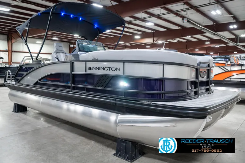 Slide: The Image of 2025 Bennington 22 MSB pontoon boat displayed indoors with blue canopy lighting. - 5