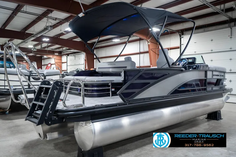 Slide: The Image of 2025 Bennington 22 MSB pontoon boat in showroom, featuring sleek design and modern amenities. - 7