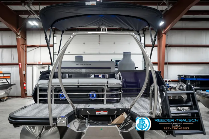 Slide: The Image of 2025 Bennington 22 MSB pontoon boat in showroom, featuring sleek design and modern amenities. - 8