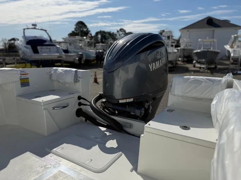 Slide: The Image of Parker 21SE boat with Yamaha outboard motor, 2025 model, in a marina setting. - 3