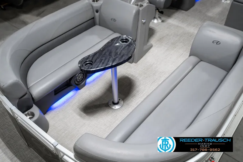 Slide: The Image of 2023 Avalon 2380 VLS boat interior with gray seating and sleek black table. - 12