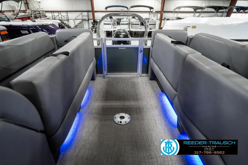 Slide: The Image of 2023 Avalon 2380 VLS boat interior with gray seating and blue LED lighting. - 26