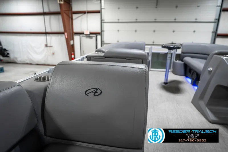 Slide: The Image of 2023 Avalon 2380 VLS boat interior with gray seating in a warehouse setting. - 27