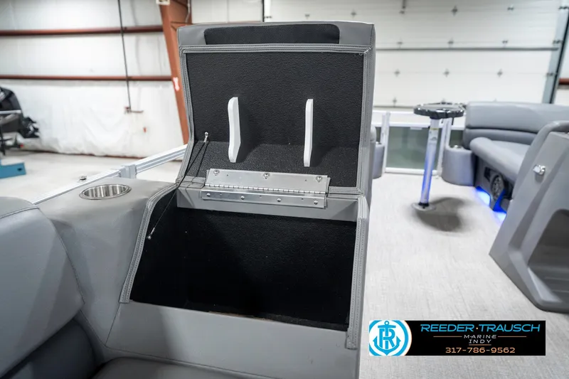 Slide: The Image of 2023 Avalon 2380 VLS boat interior with open storage compartment and cup holder. - 28