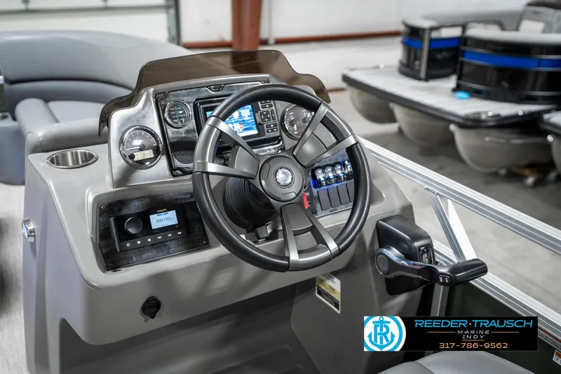 Slide: The Image of 2023 Avalon 2380 VLS boat dashboard with steering wheel and control panel. - 32