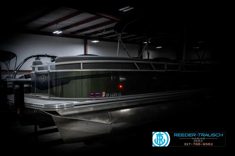 Slide: The Image of 2023 Avalon 2380 VLS pontoon boat in a dimly lit indoor setting. - 4