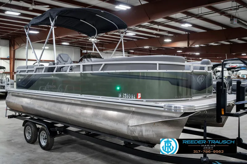 Slide: The Image of 2023 Avalon 2380 VLS pontoon boat on trailer in indoor showroom. - 6