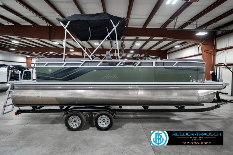 Slide: The Image of 2023 Avalon 2380 VLS pontoon boat in a warehouse, side view on a trailer. - 7