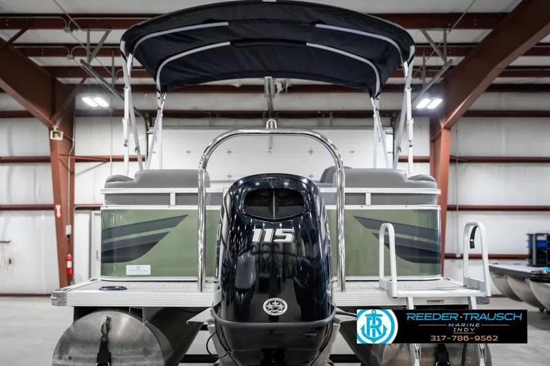 Slide: The Image of 2023 Avalon 2380 VLS pontoon boat with 115 HP engine in indoor showroom. - 9