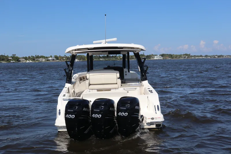 Slide: The Image of 2023 Boston Whaler 350 Realm with triple 400 horsepower engines on open water. - 11