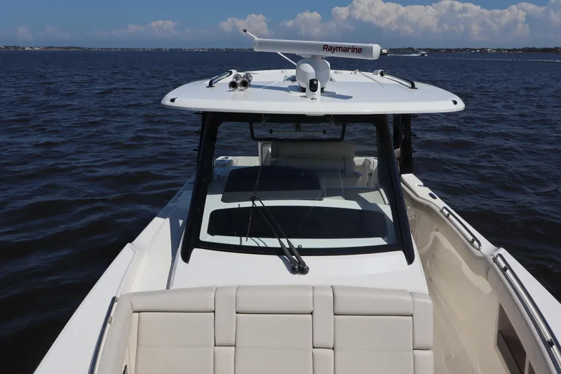 Slide: The Image of 2023 Boston Whaler 350 Realm boat on open water, featuring sleek design and advanced navigation equipment. - 14