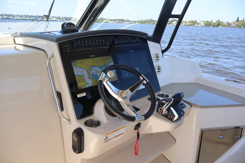 Slide: The Image of 2023 Boston Whaler 350 Realm helm with advanced navigation system and steering wheel. - 22