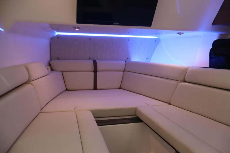 Slide: The Image of 2023 Boston Whaler 350 Realm interior with plush seating and ambient lighting. - 29