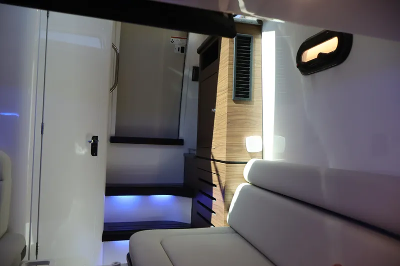 Slide: The Image of Interior of 2023 Boston Whaler 350 Realm, featuring modern seating and ambient lighting. - 30