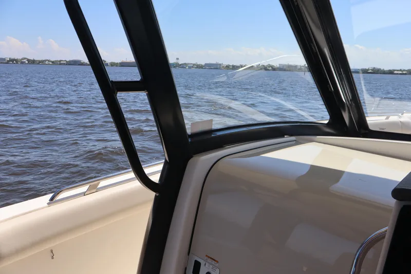 Slide: The Image of 2023 Boston Whaler 350 Realm interior view with ocean backdrop. - 34