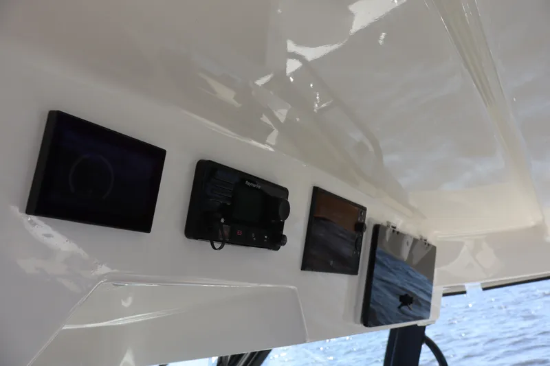 Slide: The Image of Control panel of 2023 Boston Whaler 350 Realm boat with navigation screens. - 36
