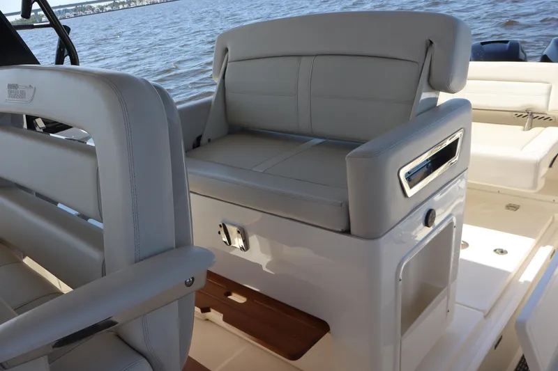 Slide: The Image of 2023 Boston Whaler 350 Realm interior with luxurious seating and ocean view. - 38