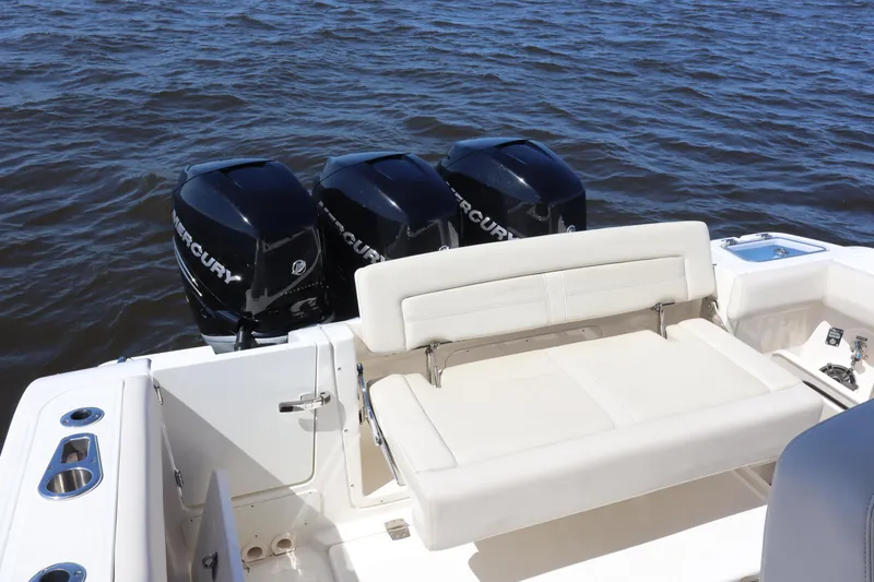 Slide: The Image of 2023 Boston Whaler 350 Realm boat with triple Mercury engines on open water. - 39