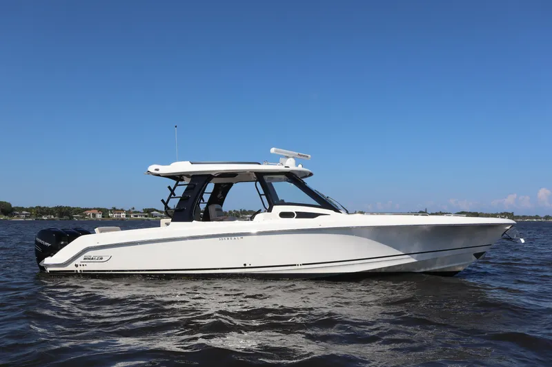 Slide: The Image of 2023 Boston Whaler 350 Realm boat on water under clear blue sky. - 4