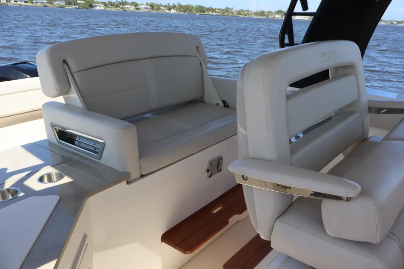 Slide: The Image of 2023 Boston Whaler 350 Realm interior seating with luxurious white upholstery. - 40