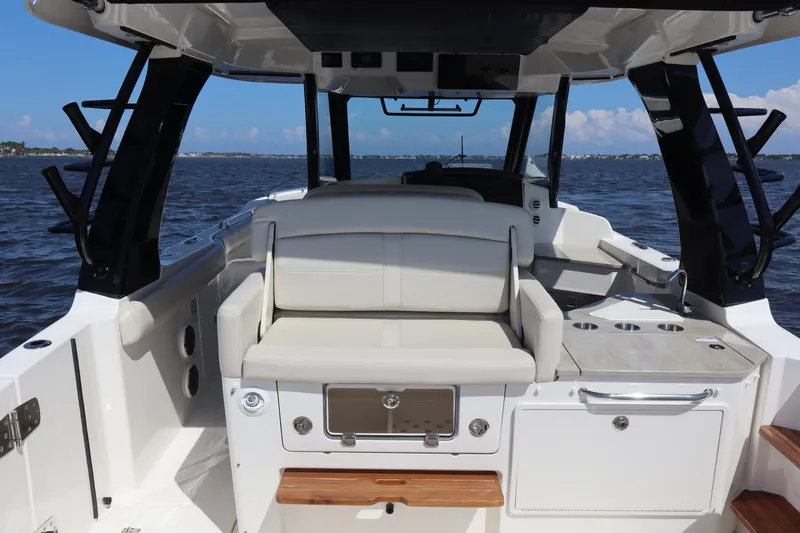 Slide: The Image of 2023 Boston Whaler 350 Realm boat interior with seating and ocean view. - 42