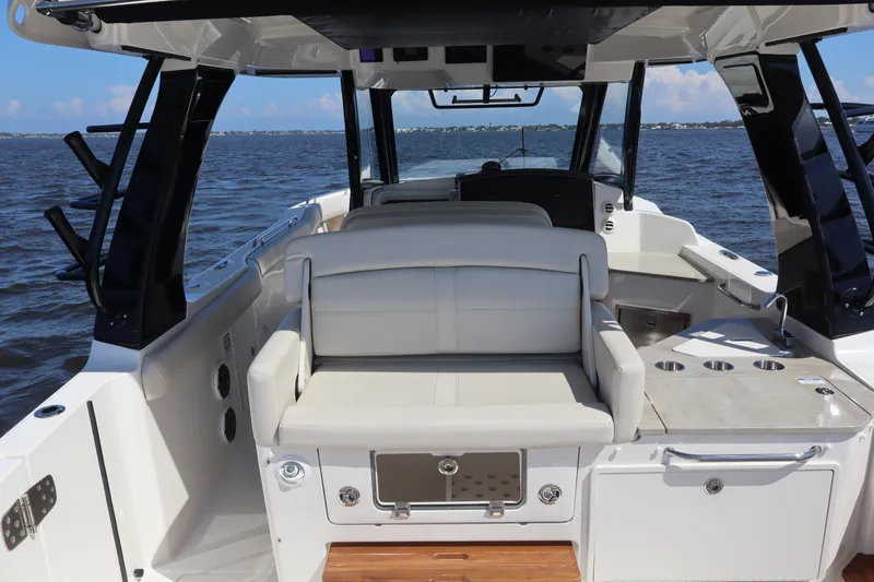Slide: The Image of 2023 Boston Whaler 350 Realm interior with seating and ocean view. - 44