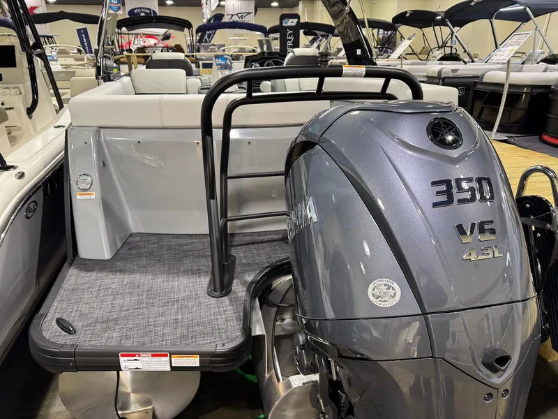 Slide: The Image of 2025 Godfrey AquaPatio 255 ULC with Yamaha 350 V6 engine at a boat show. - 13