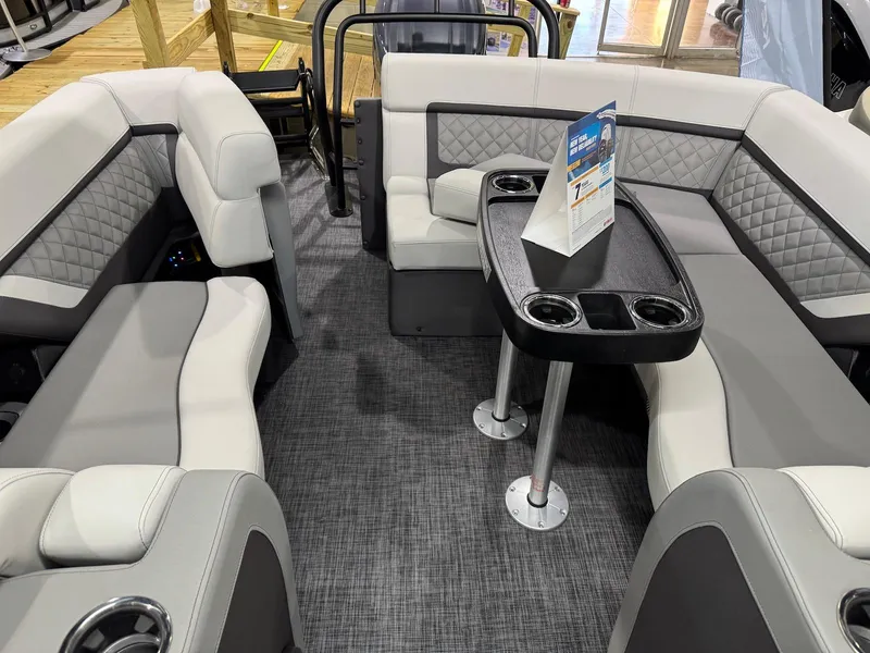 Slide: The Image of Interior of 2025 Godfrey AquaPatio 255 ULC pontoon boat with luxurious seating and table. - 6