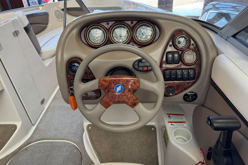 Slide: The Image of 2004 Four Winns 210 Horizon boat dashboard with steering wheel and instrument panel. - 10