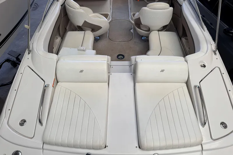 Slide: The Image of 2004 Four Winns 210 Horizon boat interior with white seating and spacious layout. - 12
