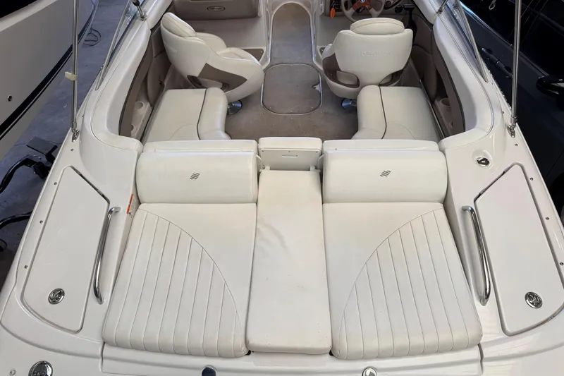 Slide: The Image of 2004 Four Winns 210 Horizon boat interior with white seating and steering wheel. - 13