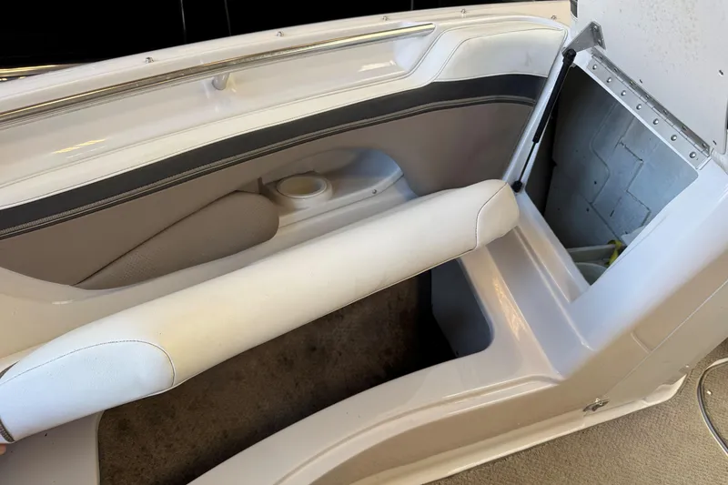 Slide: The Image of Interior view of a 2004 Four Winns 210 Horizon boat, featuring seating and storage. - 16
