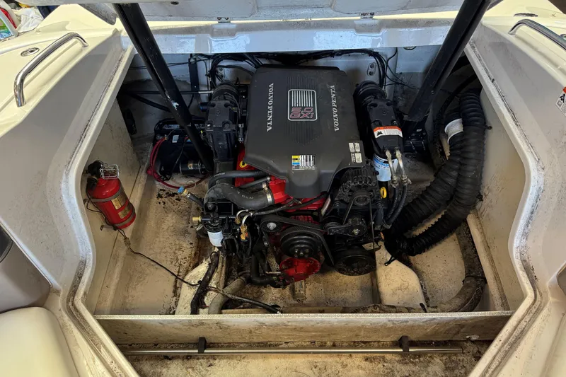 Slide: The Image of Engine compartment of a 2004 Four Winns 210 Horizon boat, featuring a Volvo Penta engine. - 19