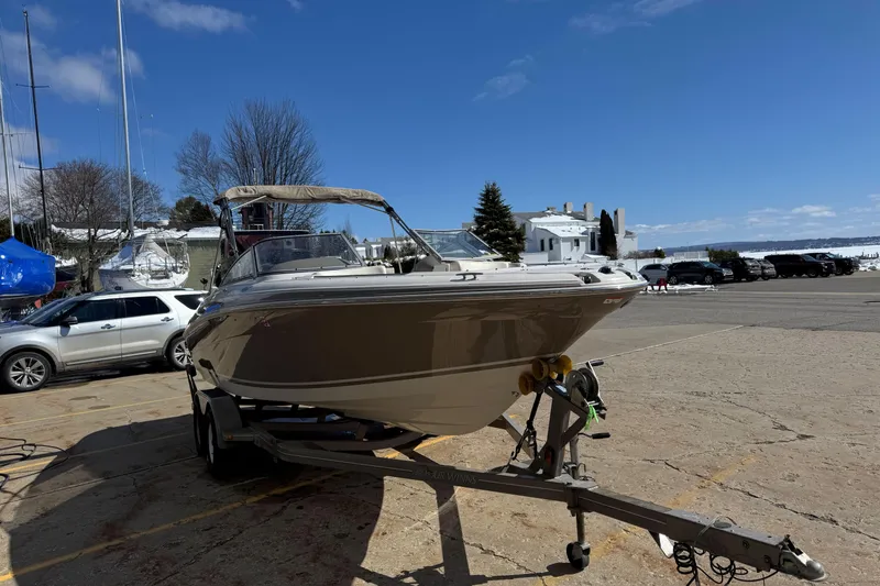 Slide: The Image of 2004 Four Winns 210 Horizon boat on trailer in marina parking lot. - 3