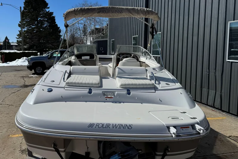 Slide: The Image of 2004 Four Winns 210 Horizon boat with seating, docked outdoors. - 6