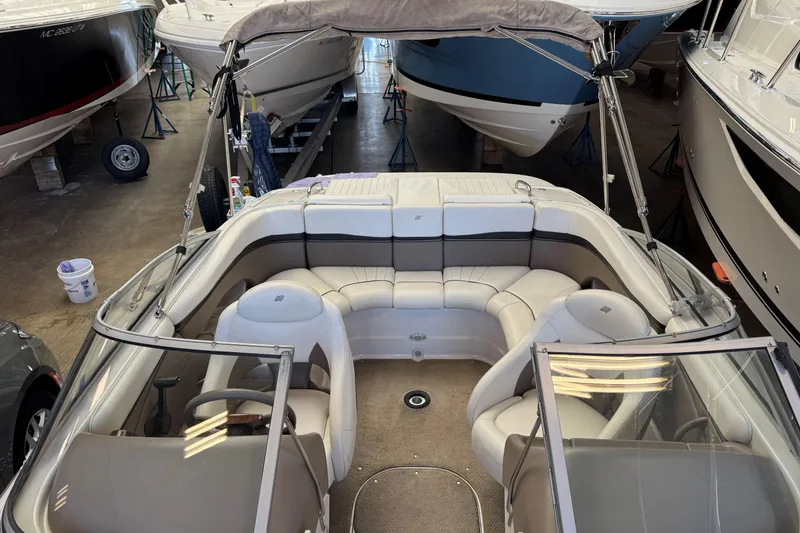 Slide: The Image of 2004 Four Winns 210 Horizon boat interior with seating, stored indoors. - 8